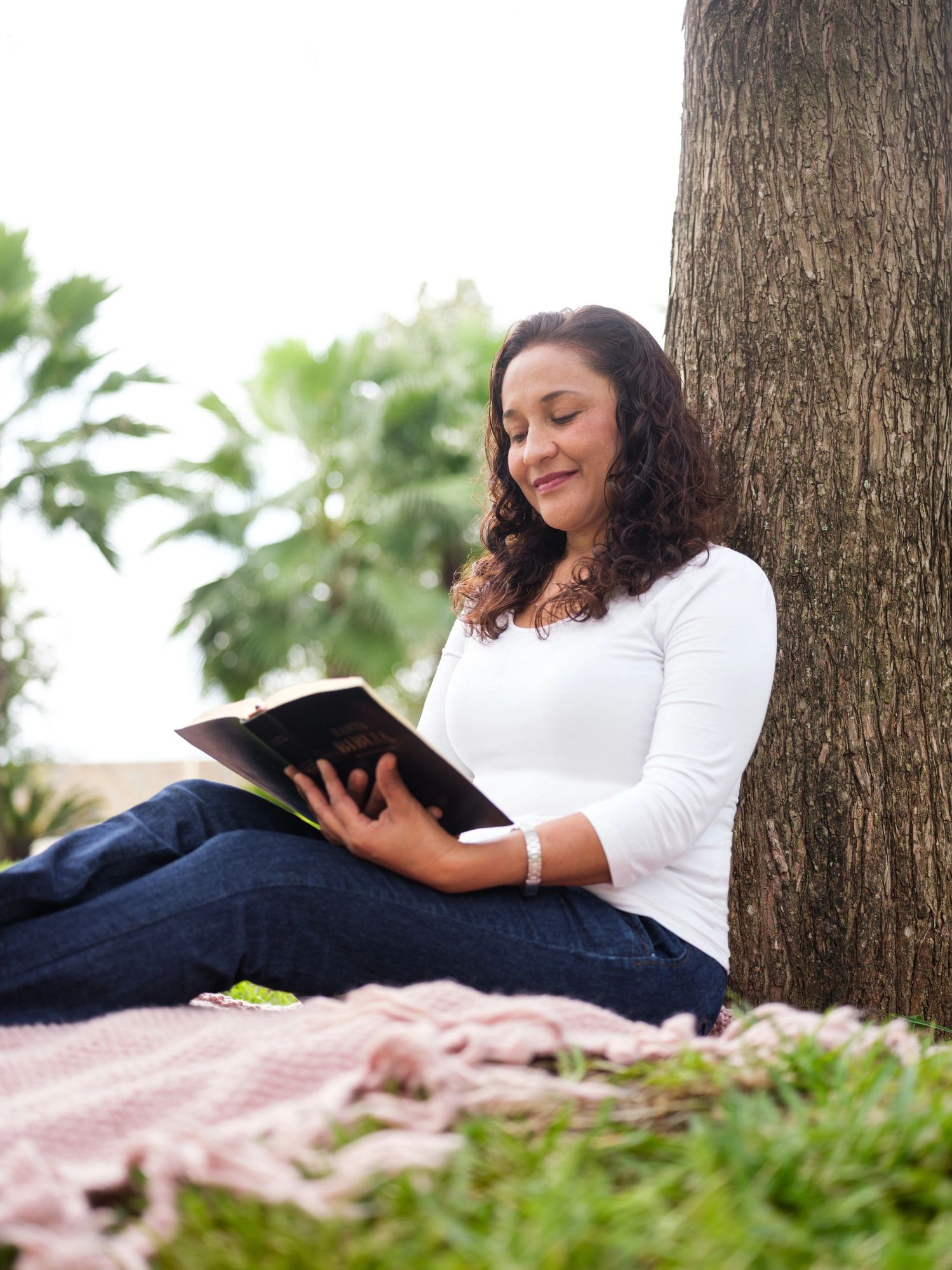 Woman reading the Bible outdoors