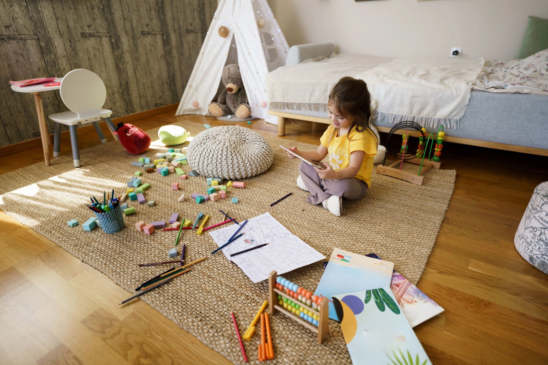 Child learning at home with a tablet and books